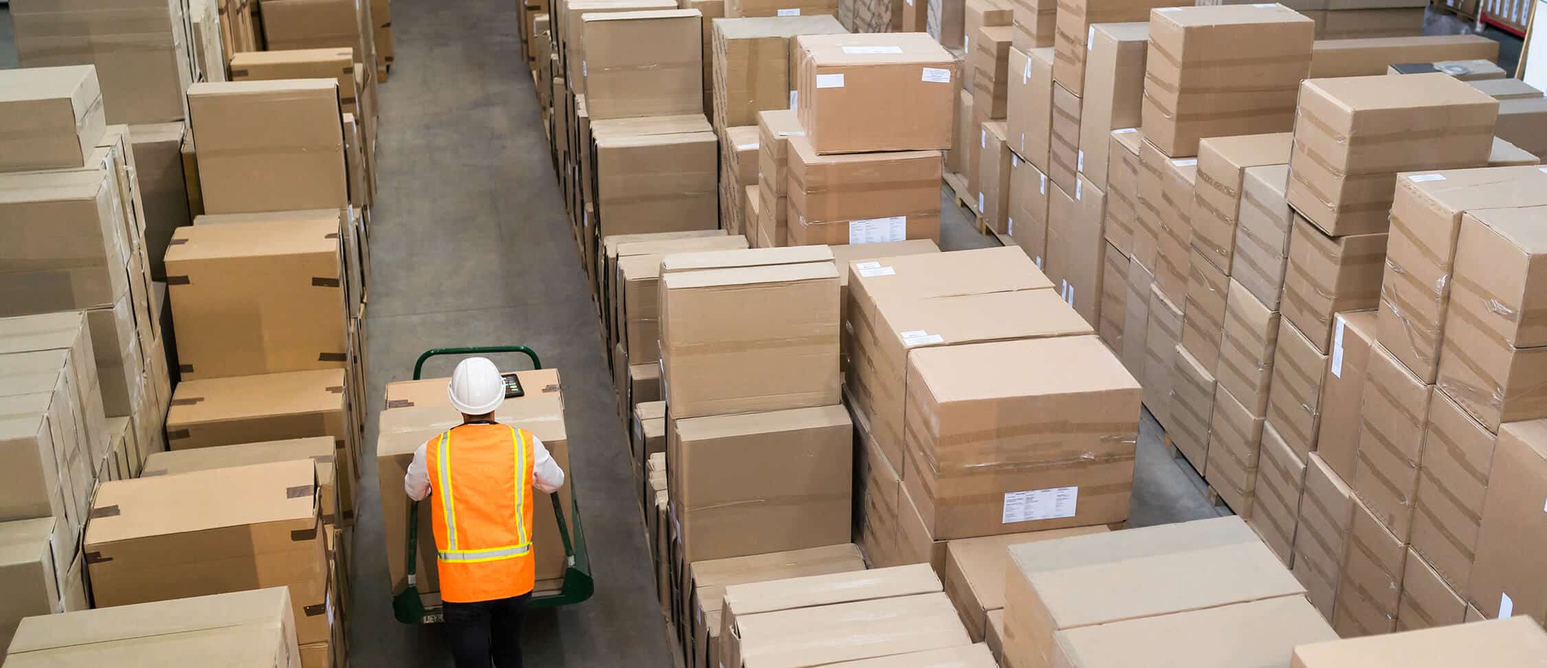 Local Storage vs Amazon FBA - a man walking through a storage warehouse